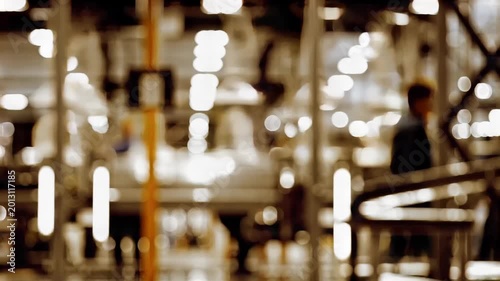 Blurred modern factory interior with workers