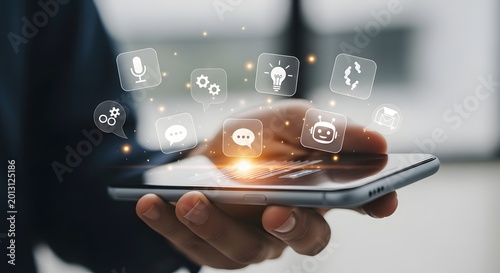 A person holding a smartphone with various app icons floating above the screen in a modern office setting.