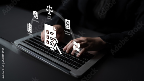 Canvas Print A focused business environment showcasing hands typing on a laptop with legal and ethical symbols, representing professionalism and integrity in the digital age