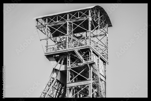 Black and white close-up photograph of a mining derrick.