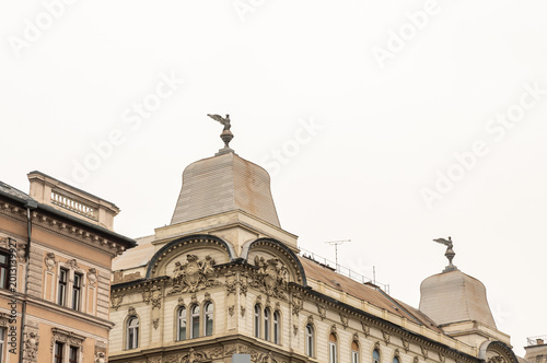 Upper part of building is decorated with stucco statues on Vaci Street in Budapest in Hungary