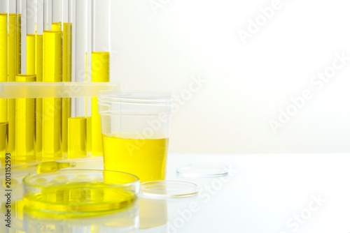 Chemical laboratory equipment. Glassware with yellow liquid for research