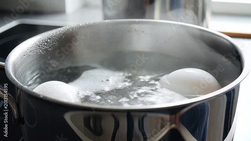 Boiling Eggs in a Pot of Water on a Stove Top 1.