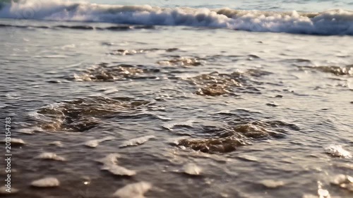 Footprints in the Sand Washed Away by Gentle Ocean Waves.