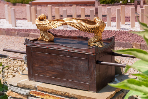 Model of the Ark of the Covenant with golden cherubim on the lid outdoors.