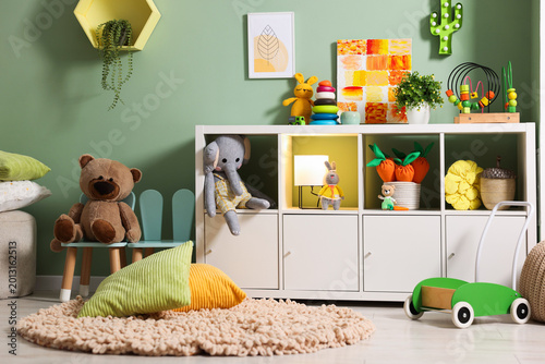 Shelving unit with toys in child's room. Interior design