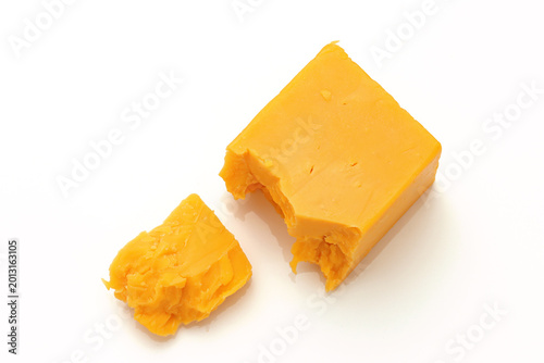 Broken Chunks of Orange Cheddar Cheese on white background
