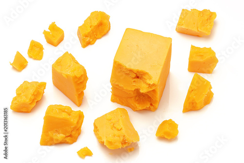 Broken Chunks of Orange Cheddar Cheese on white background