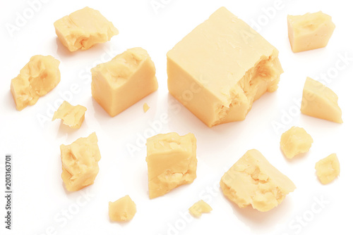 Fotografie Broken Chunks of White Cheddar Cheese on white background