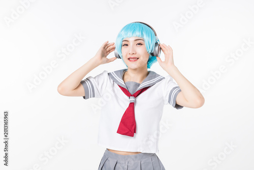 Cuadro en lienzo Smiling anime cosplay student listening to music with headphones