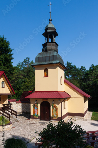 Holy Spirit church tower and entrance in Czatachowa village, Jura region, Poland.