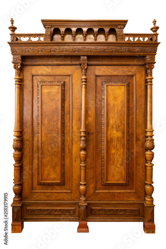 Antique tall wooden wardrobe with ornate carving and columns