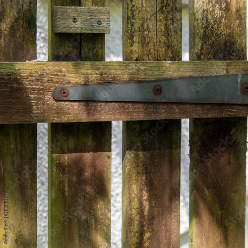 Obraz na plátně Weathered wooden fence with metal hinge
