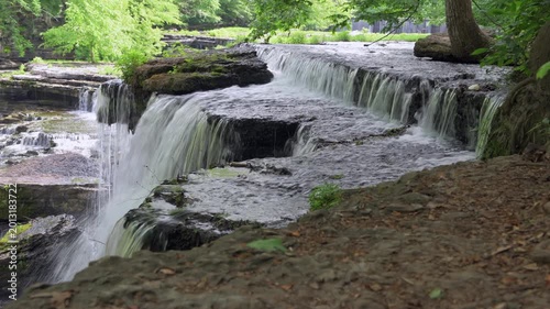 A beautiful flowing water formation under a canopy of trees called Blue Holes Falls shows the surreal, peaceful atmosphere of Old Stone Fort State Park in Tennessee.