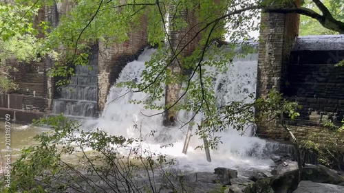 A spillway on a dam in Cumberland State Park in Tennessee shows the lake level control as water spills out the back of the dam for level control.