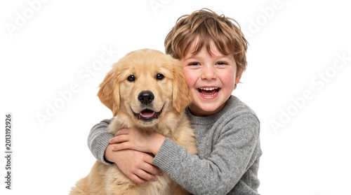 Happy boy hugging a golden retriever puppy 