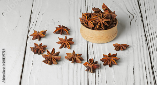 Canvastavla Star anise, or badian, is a star-shaped fruit with seeds inside, on a white background