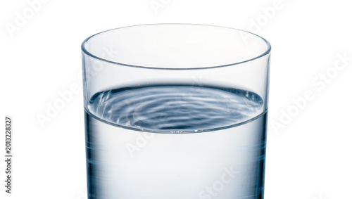 Fotografia Isolated transparent glass filled with clean refreshing water showing dynamic surface ripples
