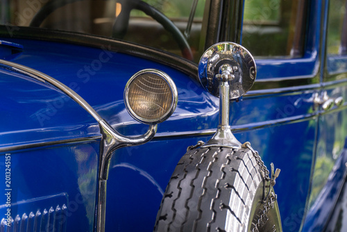 Fotografie Detailed view of a bright blue vintage car featuring a side mounted spare tire c