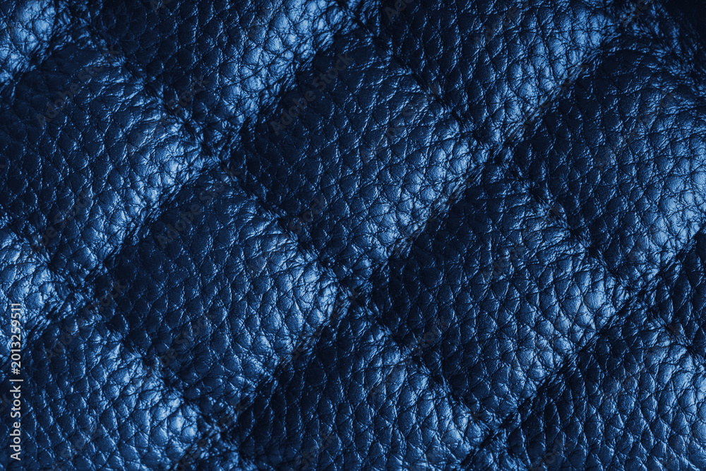 Obraz premium Close up, macro of blue quilted leather texture with stitched diamond pattern, luxury material surface shining metal effect for fashion, upholstery or design wallpaper, rough, relief background