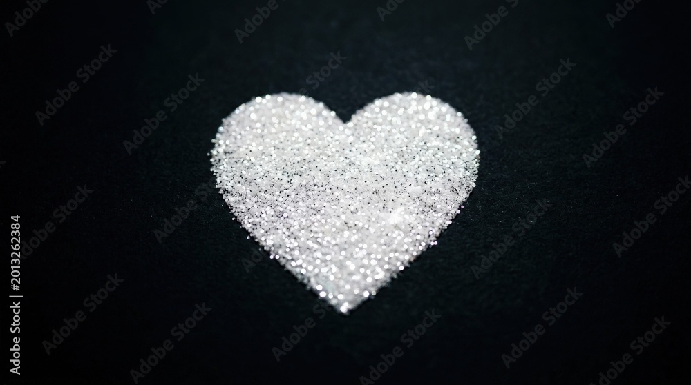Fototapeta premium Heart shape made of sparkling white glitter on black background, romantic celebration concept, elegant minimal composition, high contrast, no logos