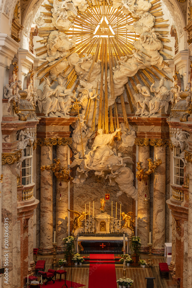 Fototapeta premium Vienna, Austria. Grand baroque high altar with golden rays and sculptures in Karlskirche