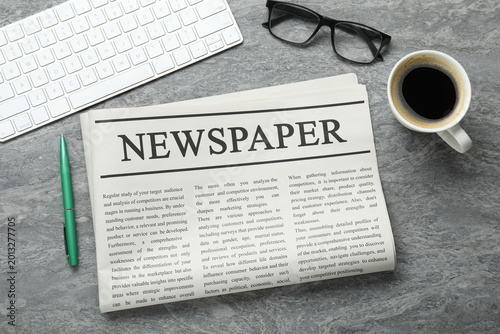 Bild auf Leinwand Newspaper, computer keyboard, pen, glasses and coffee on grey table, flat lay