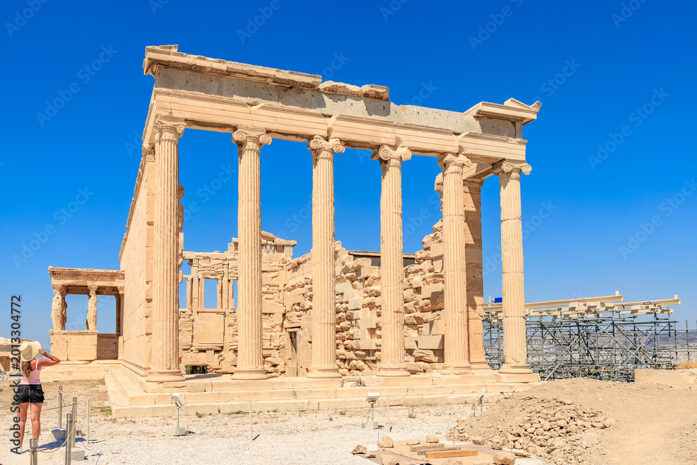 Fototapeta premium A large building with columns and a blue sign, Acropolis in Athens