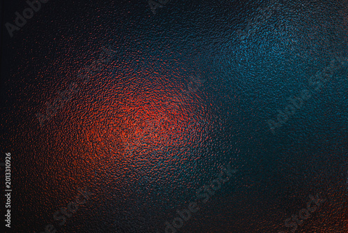 Dark textured background illuminated by contrasting red and teal neon lights