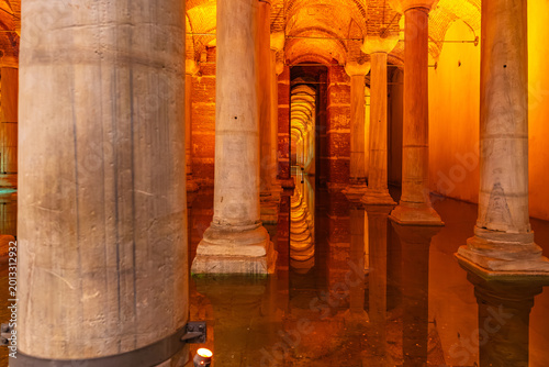 фотографія Ancient underground basilica cistern with illuminated columns and reflection in
