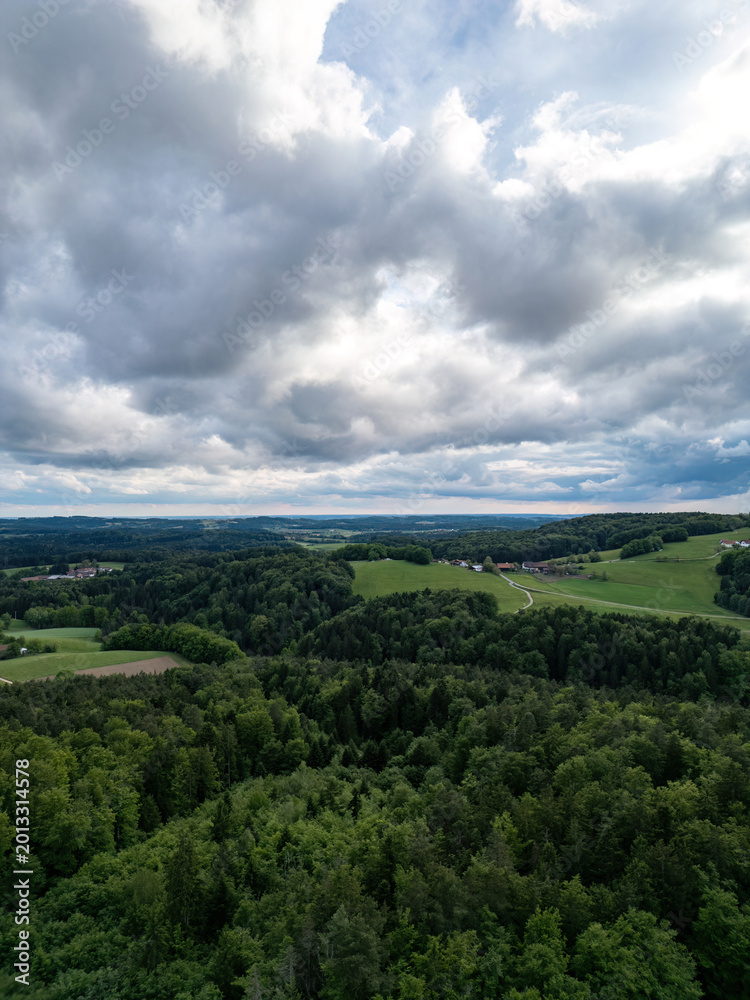Obraz premium Drone panorama of rural landscape near Zenting in Bavarian Forest with dramatic clouds and green hills