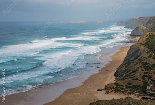 View from Castelejo Viewpoint over Praia do Castelejo in Vila do Bispo, Algarve, Portugal, with Atlantic ocean, cliffs, beach, and surf
