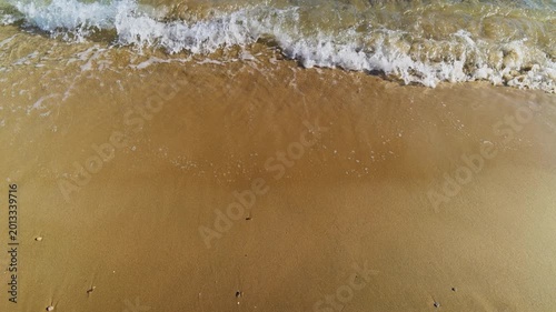 Gentle Sea Waves Crashing on Golden Sandy Beach