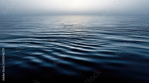 Serene ocean surface with gentle ripples reflecting soft light.