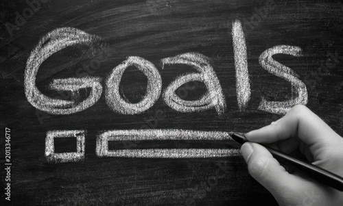 Setting Goals Hand with Pen Marking Checklist on Blackboard.