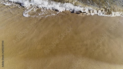 Gentle Sea Waves Crashing on Golden Sandy Beach