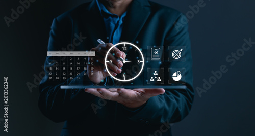 Bilde på lerret Businessman using digital time management interface with clock, calendar, task c