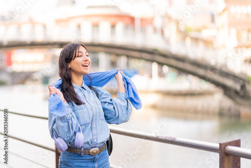 Young woman smiling laughing with scarf outdoors