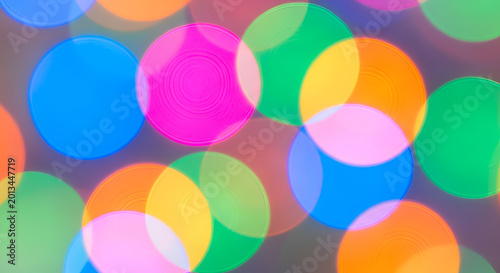 Vibrant multicolored bokeh light circles background.