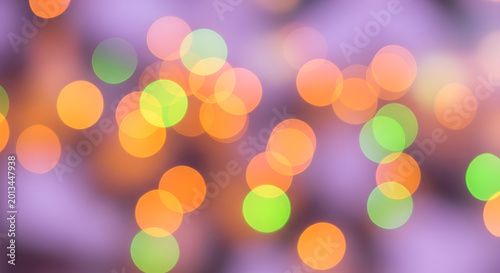 Vibrant colorful bokeh light purple background.