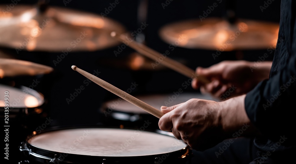 Naklejka premium drummer hands playing snare drum with drumsticks