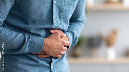 Man suffering from stomach ache holding painful abdomen