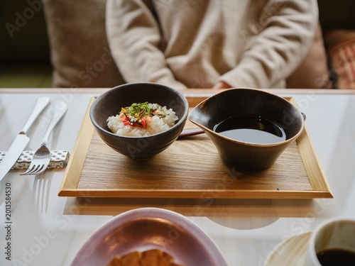 close up of a rice bowl and soup on table