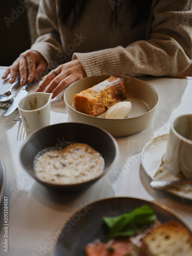 close up of a women hand and a table of breakfast