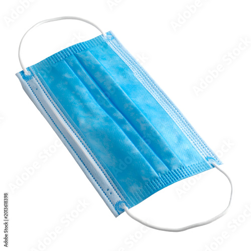 A single, light blue medical mask with an elegant, clean design and elastic ear loops. This mask, crafted for protection, is laid out with precision.