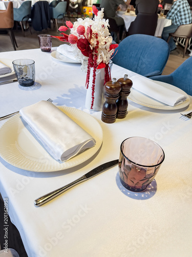 A Beautifully Set Dining Table Featuring Elegant Tableware, Decorative Centerpiece, and a Warm Ambiance Ideal for Fine Dining Experiences