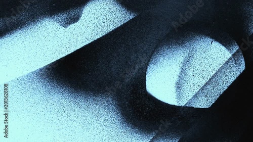 Spray paint mist on black background. Aerosol paint particles floating in dark studio.