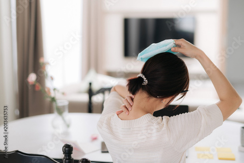 Billede på lærred Young adult woman experiencing pain and discomfort from bad headache applying an