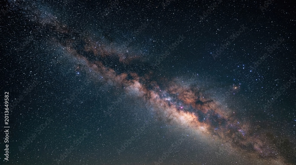 Fototapeta premium The image showcases the Milky Way galaxy, a vast spiral galaxy filled with countless stars and interstellar dust.