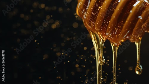 Macro Close Up of Golden Honey Dripping from Wooden Dipper